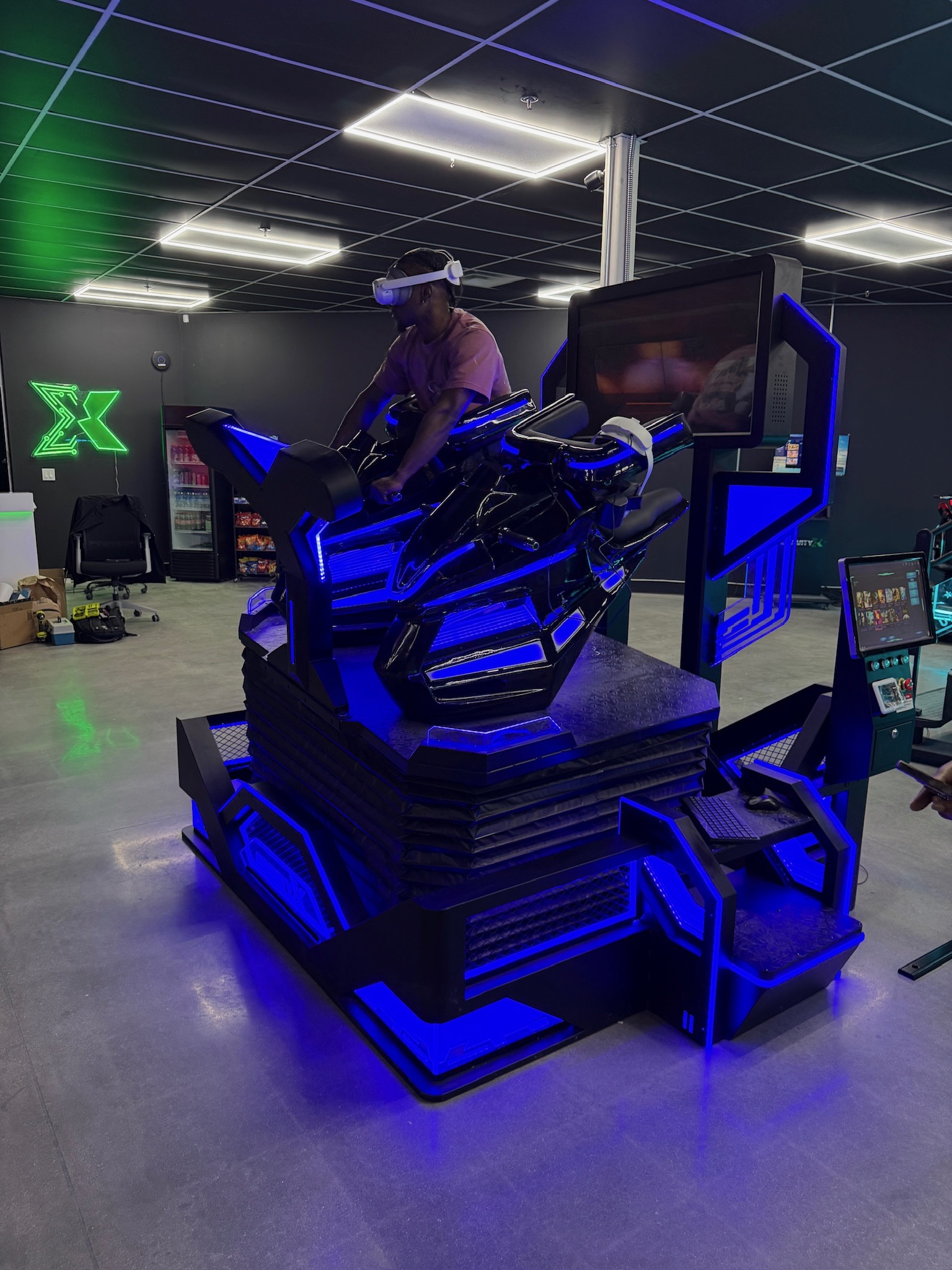 Rider on the VR motorcycle simulator with GravityX neon logo